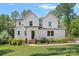 Charming two-story home with a manicured lawn, lush landscaping, and a welcoming front porch at 4195 Island Fox Ln, Denver, NC 28037