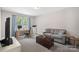 Cozy living room featuring a sofa, desk, and natural light from the window at 4195 Island Fox Ln, Denver, NC 28037