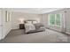 Cozy main bedroom with neutral tones, decorative lamps, and a large window at 4195 Island Fox Ln, Denver, NC 28037