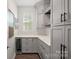 Butler's pantry featuring custom cabinetry, quartz countertops, and a beverage cooler at 4195 Island Fox Ln, Denver, NC 28037