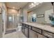 Well-lit bathroom features a glass shower, double vanity, and granite countertops at 4502 Middlebury Ln, Fort Mill, SC 29715