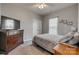 Cozy bedroom featuring neutral walls, ceiling fan, and ample natural light from the window at 4502 Middlebury Ln, Fort Mill, SC 29715