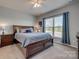Comfortable bedroom features a ceiling fan, large window, and neutral color scheme at 4502 Middlebury Ln, Fort Mill, SC 29715