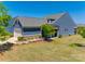 Beautiful blue home featuring a two-car garage, manicured lawn, and stone accents at 4502 Middlebury Ln, Fort Mill, SC 29715