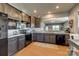 Modern kitchen with granite countertops, stainless steel appliances, and dark wood cabinets at 4502 Middlebury Ln, Fort Mill, SC 29715