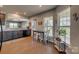 Open kitchen layout flows into a dining area, filled with natural light at 4502 Middlebury Ln, Fort Mill, SC 29715