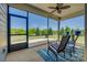 Cozy screened-in patio with chairs and an open view to a nicely landscaped lawn with lush trees at 4502 Middlebury Ln, Fort Mill, SC 29715
