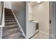 Carpeted staircase leads to a convenient laundry area with modern washer and dryer at 4502 Middlebury Ln, Fort Mill, SC 29715