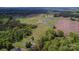 Aerial view of the home with a large park nearby, surrounded by lush trees and a winding path at 4773 Westwinds Rd, Lincolnton, NC 28092