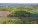 Wide aerial view of the home and its surrounding area with wooded areas and open land at 4773 Westwinds Rd, Lincolnton, NC 28092