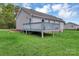 Back exterior view of a house with a large deck overlooking a spacious yard at 4773 Westwinds Rd, Lincolnton, NC 28092