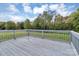 Back deck with gray railings overlooking a green yard with tree line at 4773 Westwinds Rd, Lincolnton, NC 28092