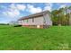 Back exterior view of a house with a deck overlooking a spacious yard at 4773 Westwinds Rd, Lincolnton, NC 28092