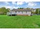 Back exterior view of a house with a deck overlooking a spacious yard at 4773 Westwinds Rd, Lincolnton, NC 28092
