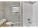 Bathroom features a shower with a window, toilet, and neutral color palette for a serene experience at 4773 Westwinds Rd, Lincolnton, NC 28092