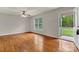 Inviting bedroom with gleaming hardwood floors, ceiling fan, and an open door to outdoor scenery at 4773 Westwinds Rd, Lincolnton, NC 28092