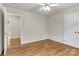 Bedroom featuring hardwood floors, a ceiling fan, a closet, and an open door showing another room at 4773 Westwinds Rd, Lincolnton, NC 28092
