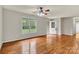 Spacious bedroom featuring hardwood floors, ceiling fan, natural light, and an open doorway at 4773 Westwinds Rd, Lincolnton, NC 28092
