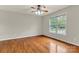 Bright bedroom with hardwood floors, ceiling fan, and a large window offering natural light at 4773 Westwinds Rd, Lincolnton, NC 28092