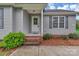Charming home entrance with brick steps, gray siding, and well-maintained landscaping for inviting curb appeal at 4773 Westwinds Rd, Lincolnton, NC 28092