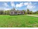Charming single-story home features gray siding, a well-manicured lawn, and inviting curb appeal at 4773 Westwinds Rd, Lincolnton, NC 28092