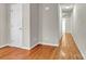 Hallway with hardwood floors, white doors and light gray walls offers classic design and functionality at 4773 Westwinds Rd, Lincolnton, NC 28092