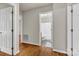 Hallway provides access to bathroom and other rooms, boasting hardwood floors and neutral wall color at 4773 Westwinds Rd, Lincolnton, NC 28092