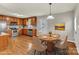 Eat-in kitchen featuring wooden cabinets, stainless steel appliances, and a charming dining area at 4773 Westwinds Rd, Lincolnton, NC 28092