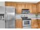 Well-equipped kitchen featuring stainless steel appliances, oak cabinets, and ample counter space for food preparation at 4773 Westwinds Rd, Lincolnton, NC 28092