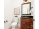 Powder room featuring dark wood vanity with granite countertop, toilet and wall art at 4904 Ardenetti Ct, Mint Hill, NC 28227
