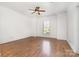 Empty bedroom with hardwood floors, a ceiling fan, and a window at 4904 Ardenetti Ct, Mint Hill, NC 28227