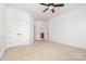 Spacious bedroom with neutral carpet and adjacent bathroom and closet area at 4904 Ardenetti Ct, Mint Hill, NC 28227