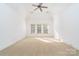 Spacious carpeted bedroom with a vaulted ceiling and multiple windows bringing in natural light at 4904 Ardenetti Ct, Mint Hill, NC 28227