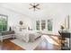 A bright main bedroom features hardwood floors, a ceiling fan, and large windows at 4904 Ardenetti Ct, Mint Hill, NC 28227