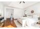 A bright main bedroom with hardwood floors, a ceiling fan, and large windows at 4904 Ardenetti Ct, Mint Hill, NC 28227