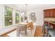 Inviting dining area with lots of windows, wood floors, modern light fixture, and bar seating nearby at 4904 Ardenetti Ct, Mint Hill, NC 28227