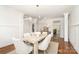 Bright dining room with wainscoting, wood floors, modern chandelier, and views to the living areas at 4904 Ardenetti Ct, Mint Hill, NC 28227