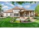 Beautiful brick home featuring a manicured lawn and rear patio at 4904 Ardenetti Ct, Mint Hill, NC 28227