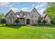 Stunning stone home with meticulously manicured lawn and mature landscaping creating a grand and welcoming curb appeal at 4904 Ardenetti Ct, Mint Hill, NC 28227
