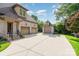 Brick exterior of home featuring multiple garages with a driveway at 4904 Ardenetti Ct, Mint Hill, NC 28227
