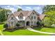 Beautiful front exterior featuring stone accents, manicured lawn, and mature landscaping at 4904 Ardenetti Ct, Mint Hill, NC 28227