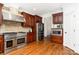Well-equipped kitchen boasts stainless steel appliances, cherry cabinets, wood floors, and granite countertops at 4904 Ardenetti Ct, Mint Hill, NC 28227