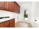 Well-lit laundry room with ample cabinetry, granite countertop and a utility sink at 4904 Ardenetti Ct, Mint Hill, NC 28227