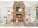 Cozy living room featuring a stone fireplace, built-in shelving, hardwood floors, and comfortable seating area at 4904 Ardenetti Ct, Mint Hill, NC 28227