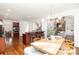 Open-concept living space connects the dining area, kitchen island, and living room with cozy fireplace at 4904 Ardenetti Ct, Mint Hill, NC 28227
