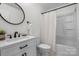 Updated bathroom featuring modern vanity, oval mirror, and shower-tub combination at 4932 Delivau Dr, Charlotte, NC 28215