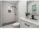 Modern bathroom with sleek vanity, tiled walk-in shower and dark accents at 4932 Delivau Dr, Charlotte, NC 28215