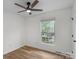 Bedroom featuring wood flooring, ceiling fan, and window at 4932 Delivau Dr, Charlotte, NC 28215