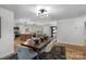 Bright dining room with open layout with wood floors flowing to living room and kitchen at 4932 Delivau Dr, Charlotte, NC 28215