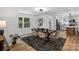 Bright dining room with wooden table, and an open concept layout to the kitchen at 4932 Delivau Dr, Charlotte, NC 28215